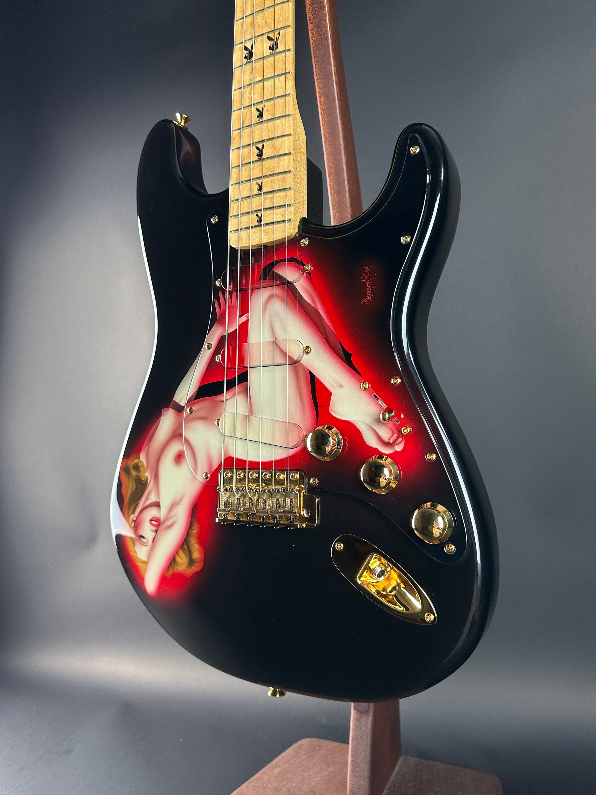 Guitar with a red and black design on a gray background