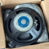 A Fender Music Receiver 4x10 inch speaker resting inside its cardboard box, surrounded by crumpled protective plastic wrapping.