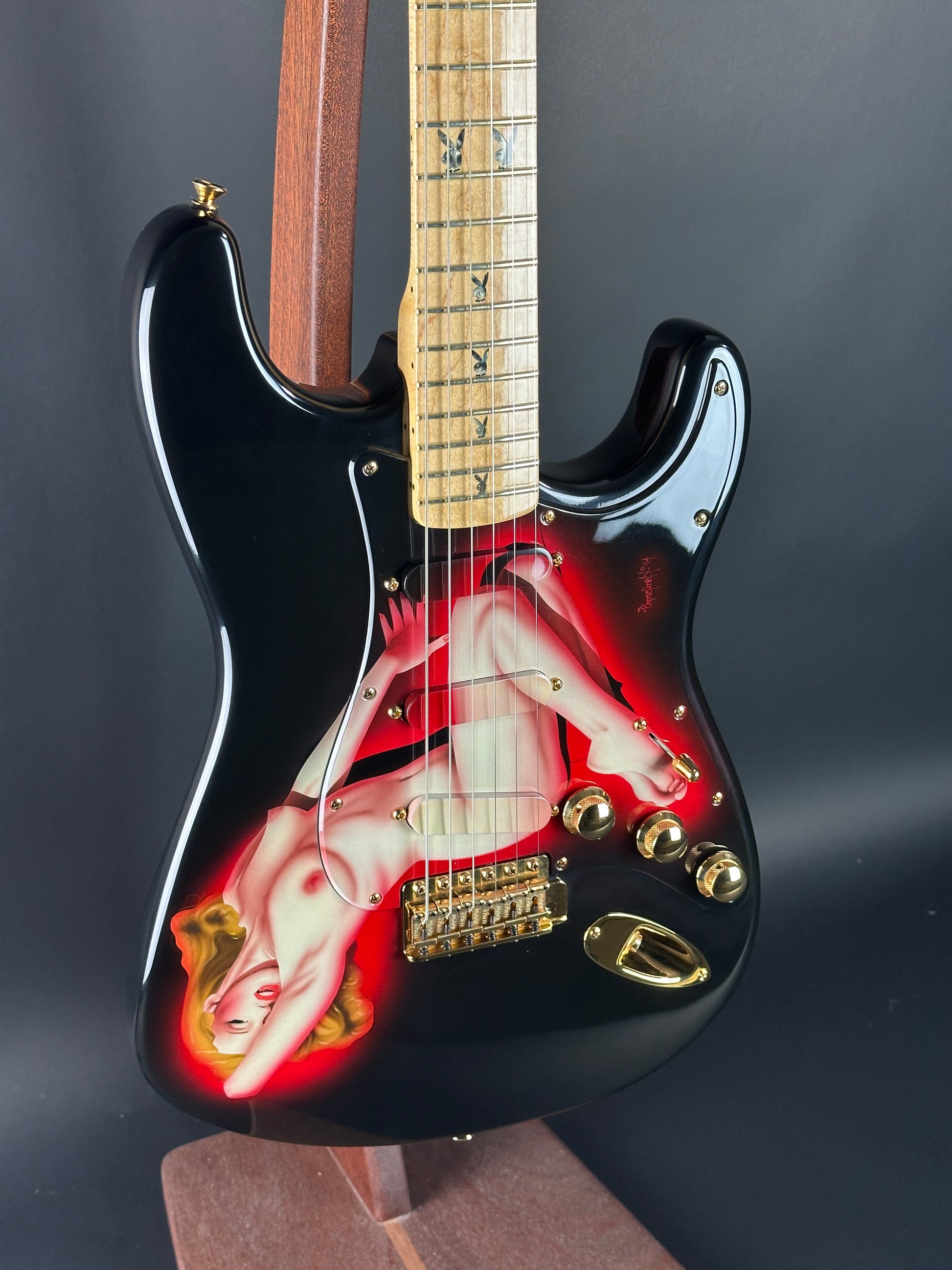 Guitar with a graphic design on the body against a dark background