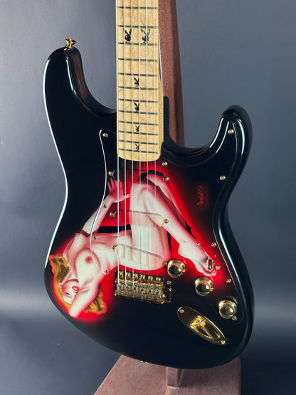 Electric guitar with a red and black design on a gray background