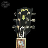 Gibson Dove guitar headstock on a black background with 'Tone Shop' logo.