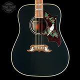 Acoustic guitar with decorative inlay on a black background, featuring the Tone Shop logo.