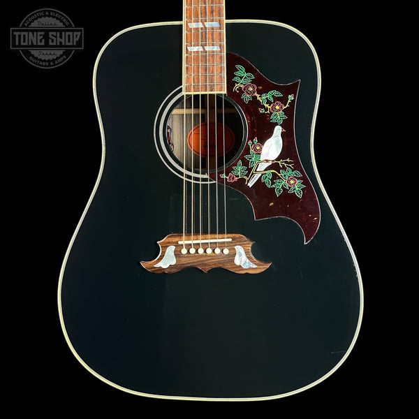 Acoustic guitar with decorative inlay on a black background, featuring the Tone Shop logo.