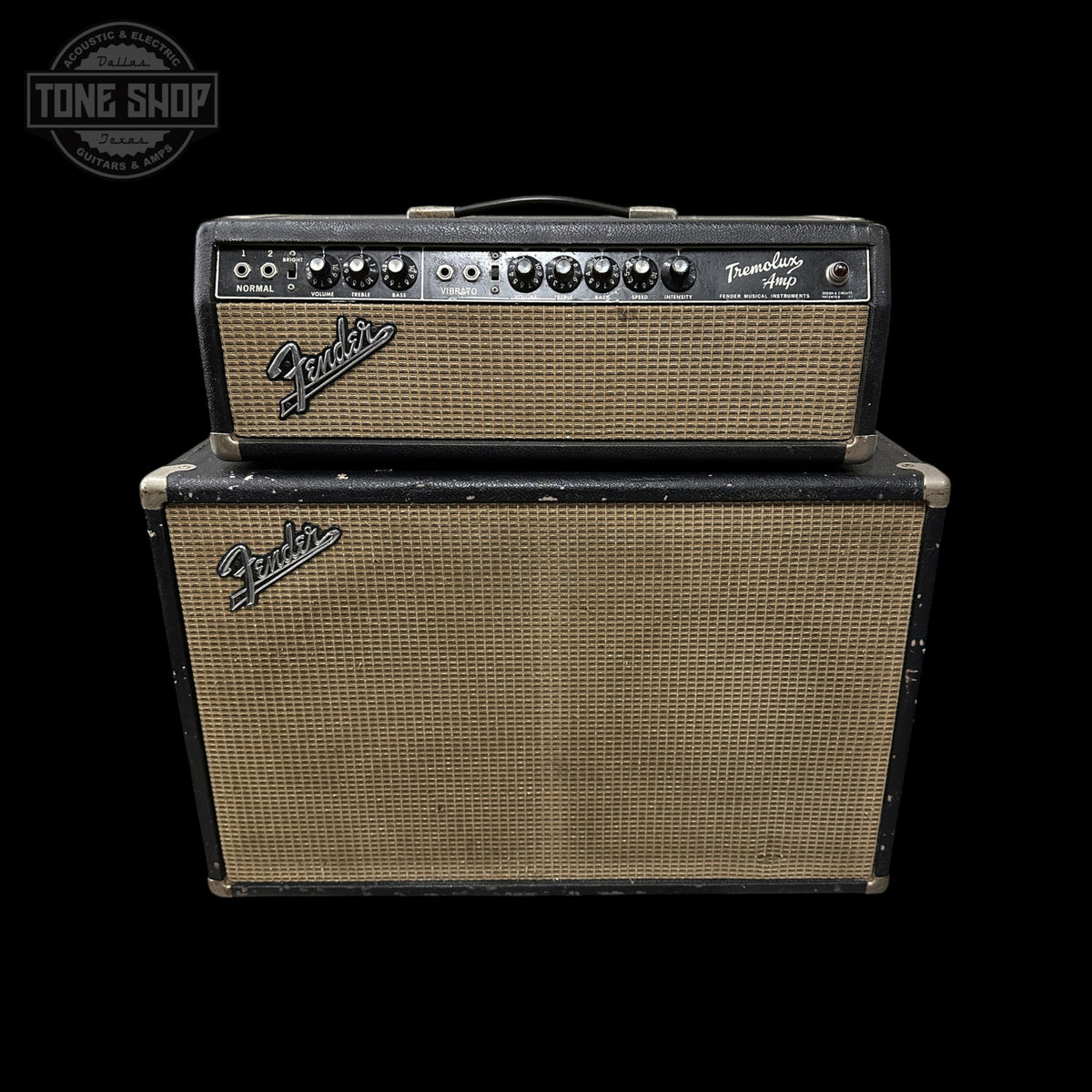 A vintage Fender Twin 100 guitar amplifier stack with a black headunit and a matching black speaker cabinet, both featuring tan mesh grilles, set against a solid black background.
