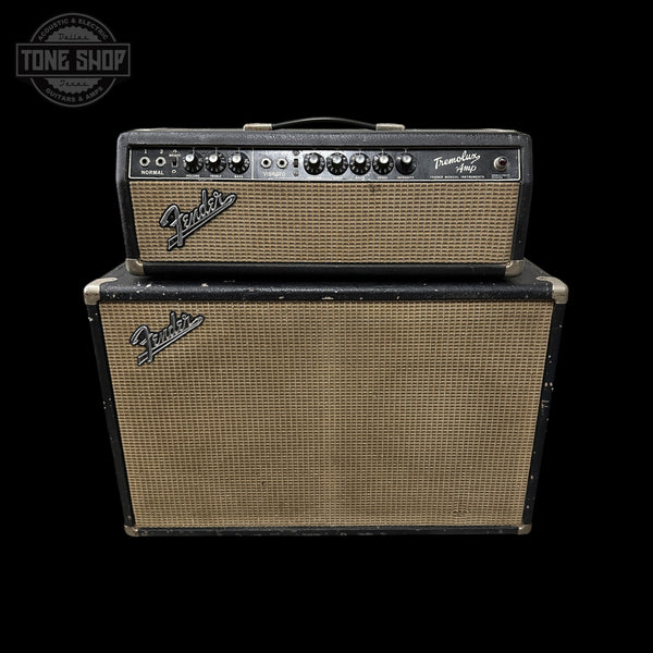 A vintage Fender Twin 100 guitar amplifier stack with a black headunit and a matching black speaker cabinet, both featuring tan mesh grilles, set against a solid black background.