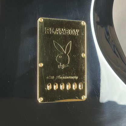 Gold Playboy plaque with rabbit logo on a dark surface