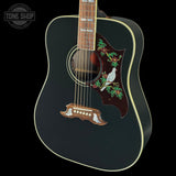 Acoustic guitar with decorative inlay on a black background, featuring the Tone Shop logo.