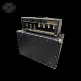 A vintage black guitar amplifier stack with a top head and a large matching speaker cabinet, photographed against a solid black background. A Tone Shop watermark is visible in the upper left corner.