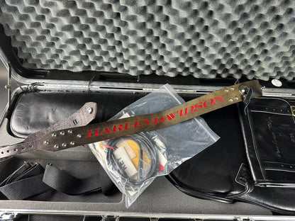 Harley-Davidson belt on a black leather bag with a textured gray background