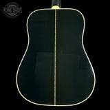 Back view of an acoustic guitar with a black finish on a black background, featuring the Tone Shop logo.