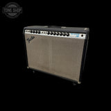 A Fender Jazz Bass AM guitar amplifier with a black cabinet, silver grille, and control knobs, shown against a solid black background with a Tone Shop watermark in the top left corner.
