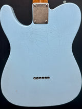 Light blue guitar body with a cracked finish on a black background
