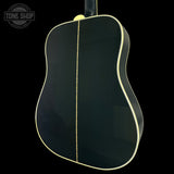 Acoustic guitar body with a visible brand logo in the corner