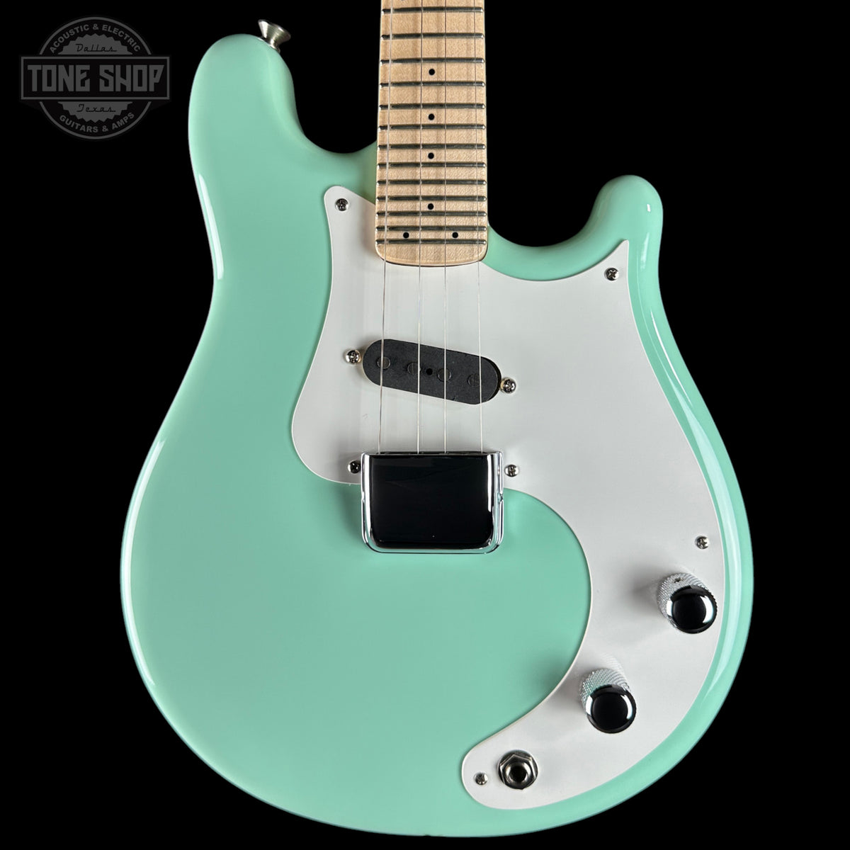 Turquoise electric guitar with a white pickguard on a black background, featuring 'Tone Shop' branding.
