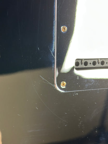 Close-up of a metallic object with screws on a reflective surface