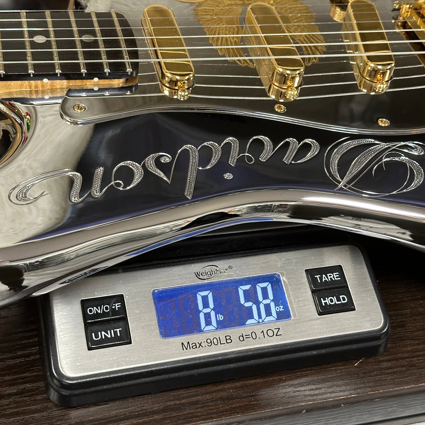 Guitar on a digital scale displaying weight