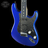 Blue electric guitar with carbon fiber texture on a black background, featuring 'Tone Shop' logo.