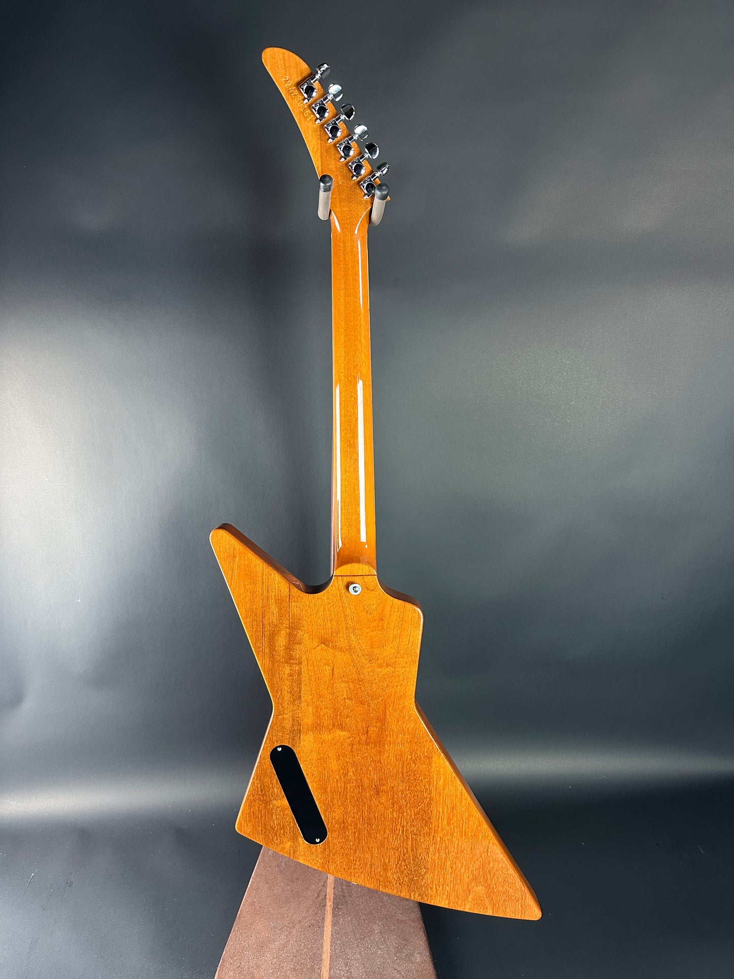 Wooden guitar with a unique body shape on a dark background