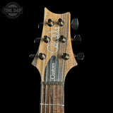 Guitar headstock with 'Custom' branding on a black background