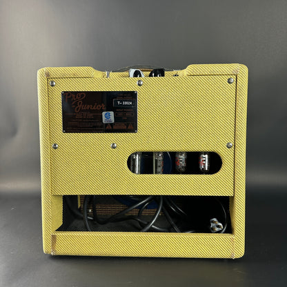 Yellow guitar amplifier with visible branding on a gray background