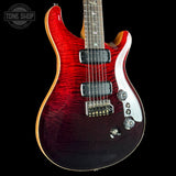 Red electric guitar with a black background