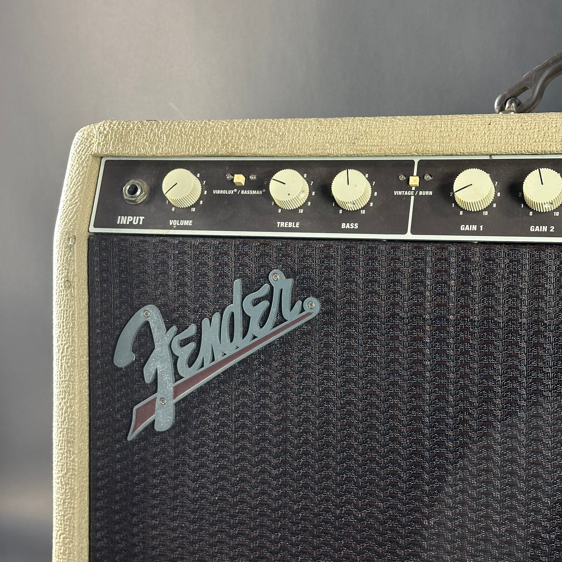 Fender amplifier with control knobs on a gray background