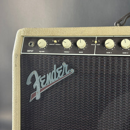 Fender amplifier with control knobs on a gray background