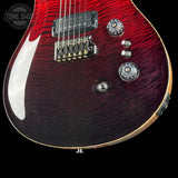 Close-up of a red electric guitar with a visible brand logo.