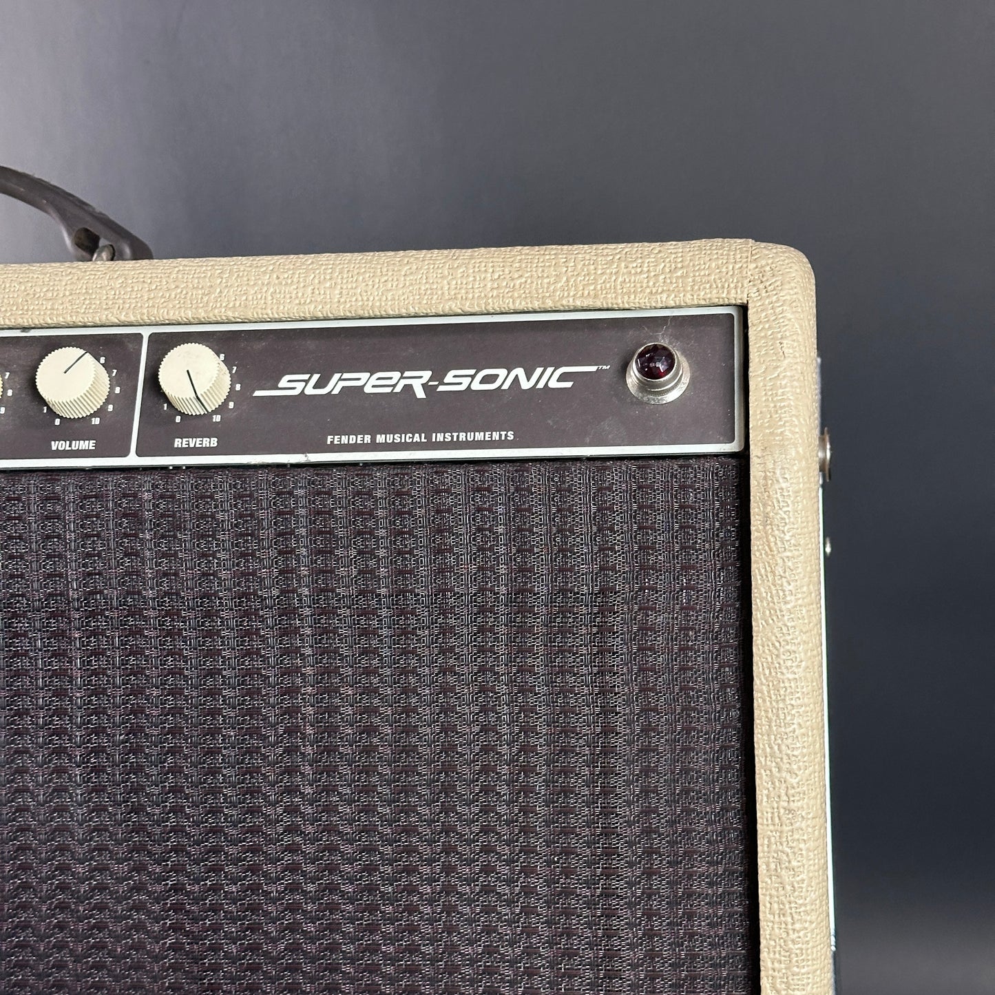 Super-Sonic guitar amplifier with a textured front panel on a dark background