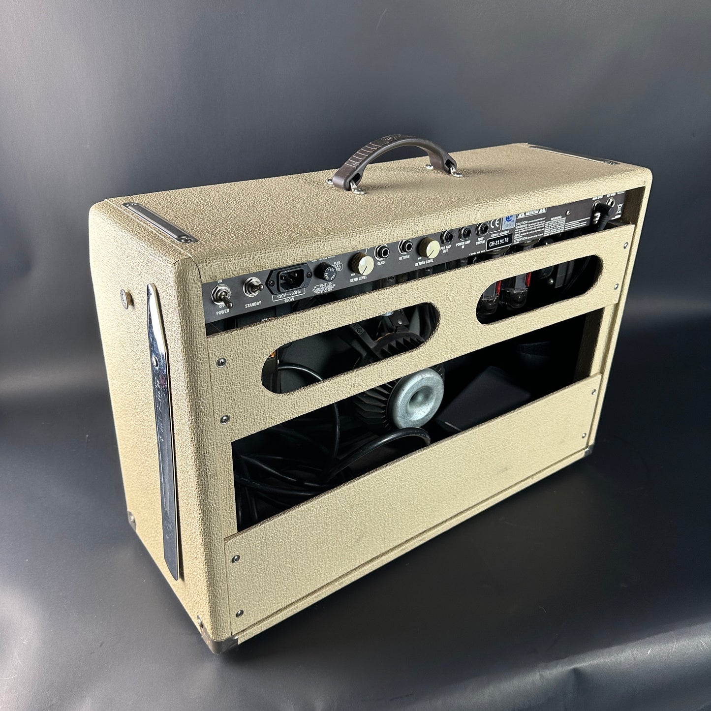 Beige guitar amplifier on a gray background