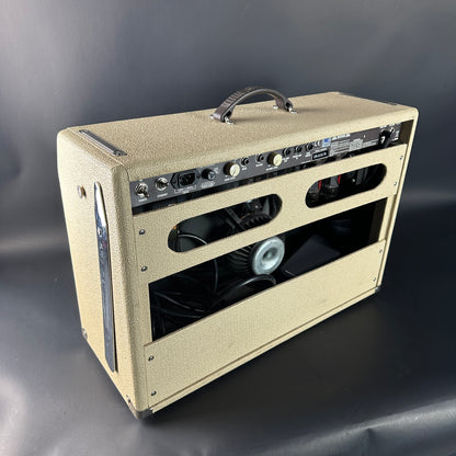 Beige guitar amplifier on a gray background
