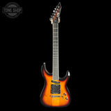 An electric guitar with a sunburst finish, featuring a bright orange and yellow center fading to black around the edges, shown against a solid black background.