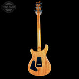 Wooden electric guitar on a black background with 'Tone Shop' logo.