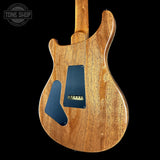 Wooden electric guitar body with a visible brand logo in the corner.