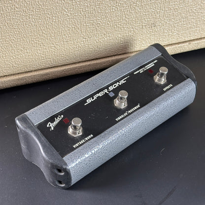 Fender Super Sonic guitar pedal on a dark surface with a beige background