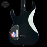 The rear view of a black electric guitar with a glossy finish, featuring a white accent stripe along the body, a silver pickguard, and a red and blue sticker on the lower left.