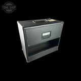 Guitar amplifier cabinet with 'Tone Shop' logo in the corner