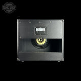 Black speaker cabinet with visible brand logo on a black background