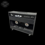 Guitar amplifier on wheels with 'Tone Shop' branding in the corner.