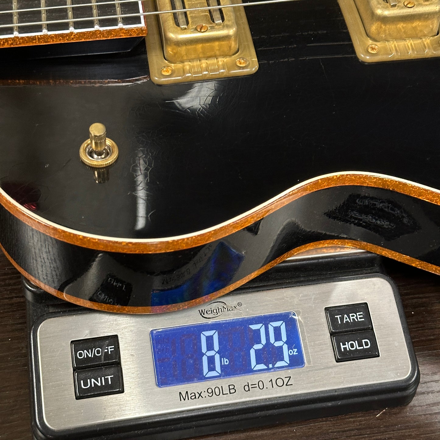 Guitar on a digital scale displaying weight