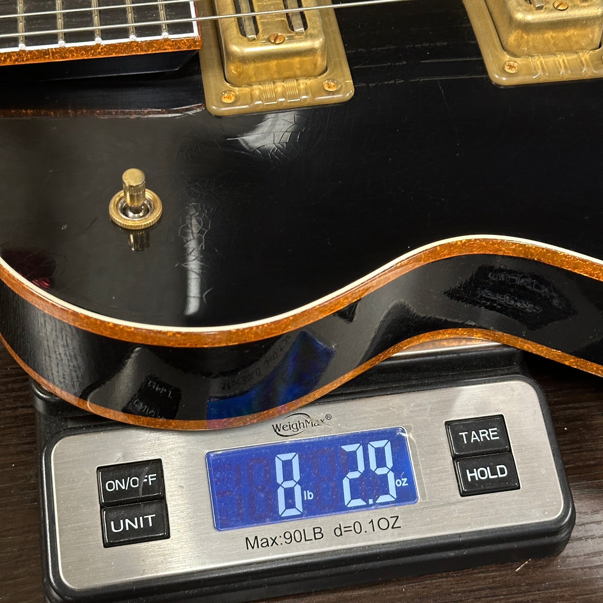 Guitar on a digital scale displaying weight