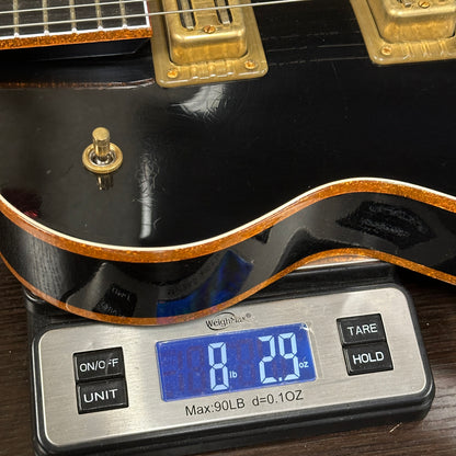 Guitar on a digital scale displaying weight