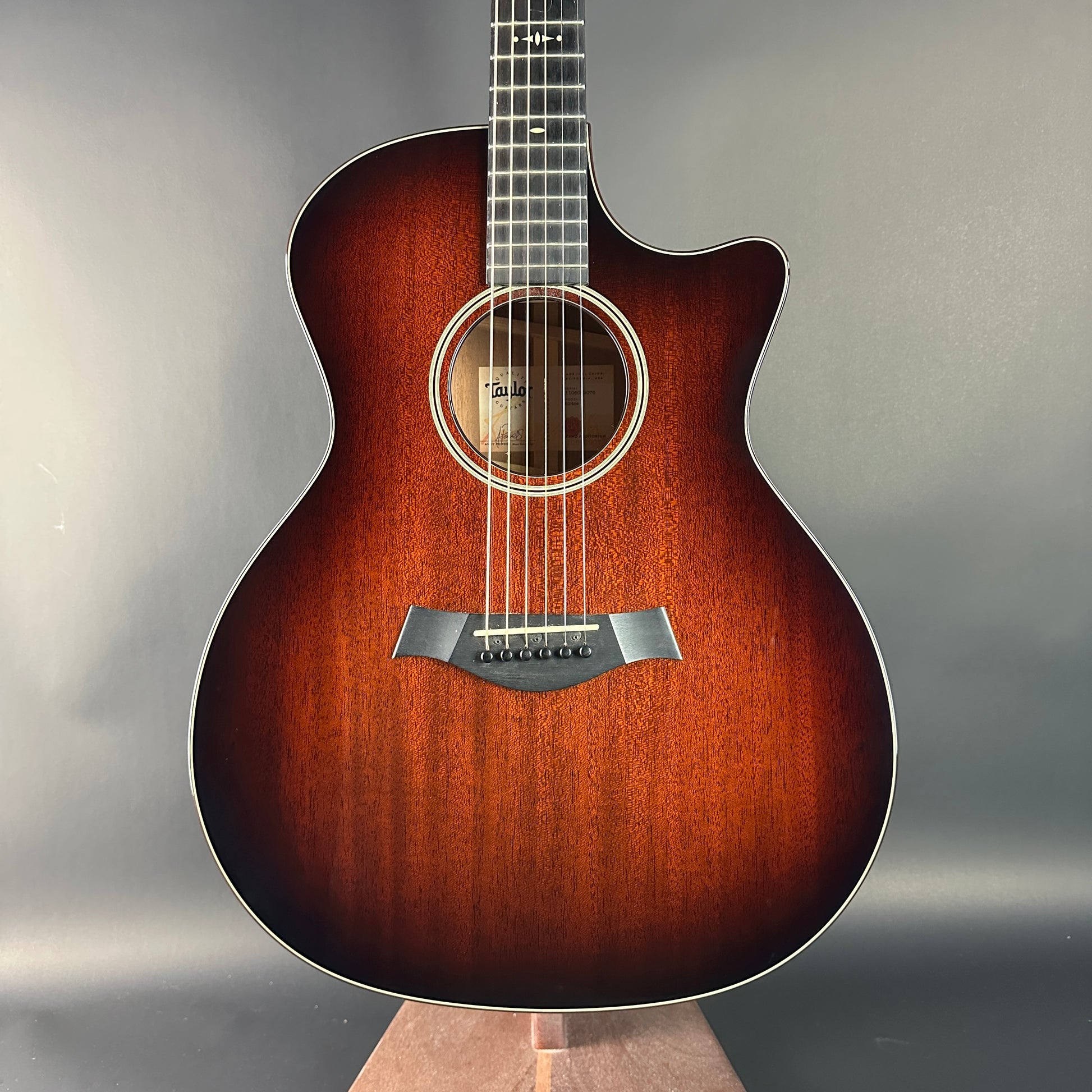 Acoustic guitar with a sunburst finish on a gray background