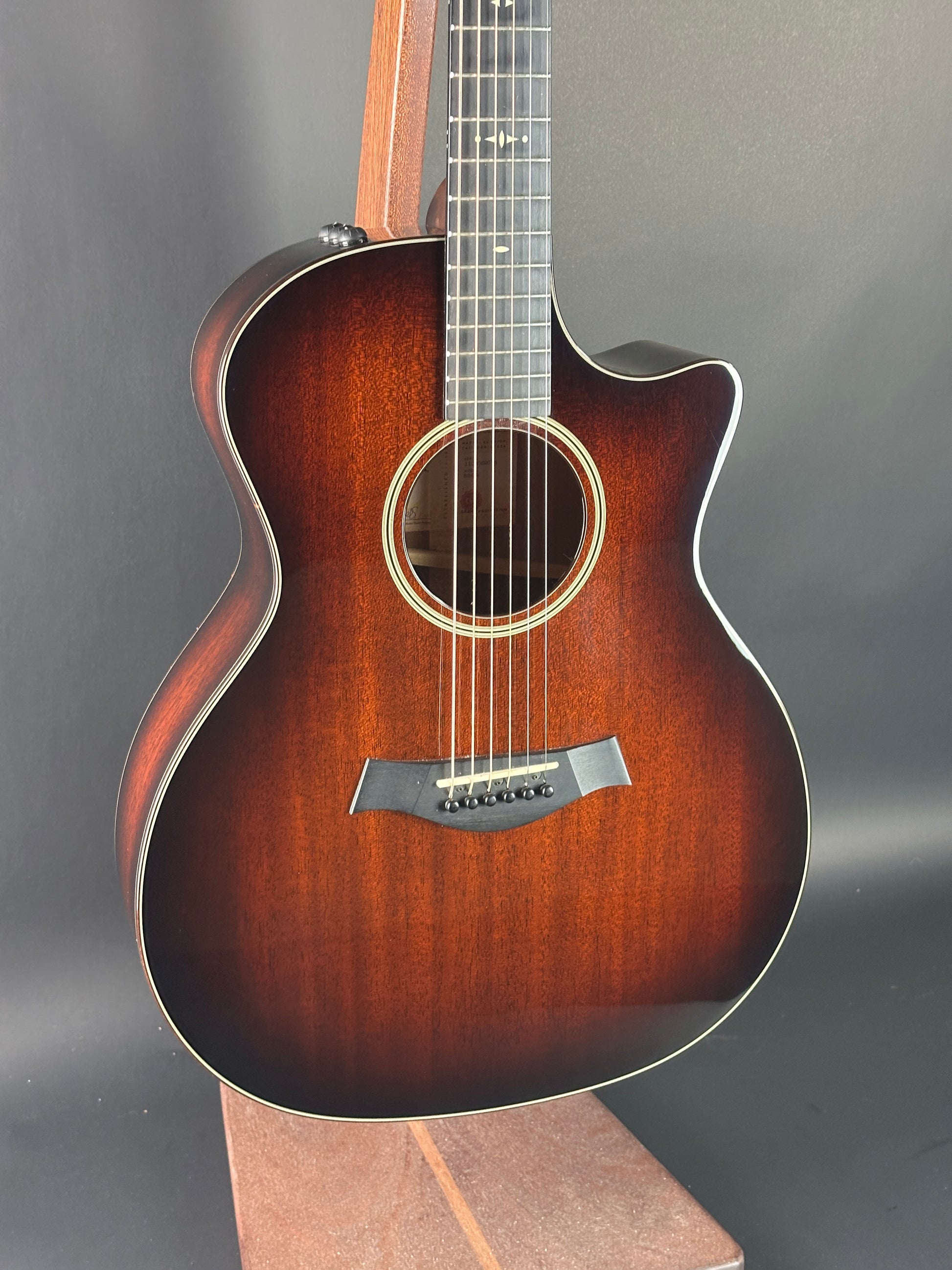 Acoustic guitar with a sunburst finish on a gray background
