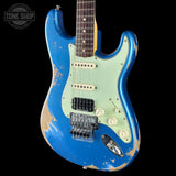 A distressed blue and mint green electric guitar with a dark wood fretboard, shown against a black background with a Tone Shop watermark in the top left corner.