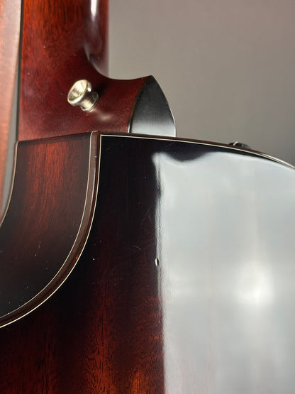 Close-up of a wooden object with a metallic component on a gray background