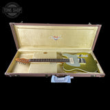 A gold glitter Fender Telecaster electric guitar resting inside an open rose gold hard case with a cream-colored interior, shown against a solid black background.