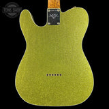 The back of a Fender Telecaster-style electric guitar body in a sparkling gold finish, shown against a solid black background with a Tone Shop watermark in the top left.