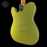 A close-up of the back of a Telecaster-style electric guitar body in a textured metallic yellow-green finish, shown against a black background with a Tone Shop watermark in the upper left.