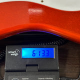Fender Custom Shop LTD 70th Anniversary 1954 Stratocaster Candy Tangerine on scale displaying weight.